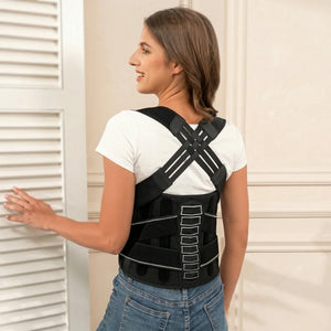 Woman wearing a black posture corrector against a neutral background